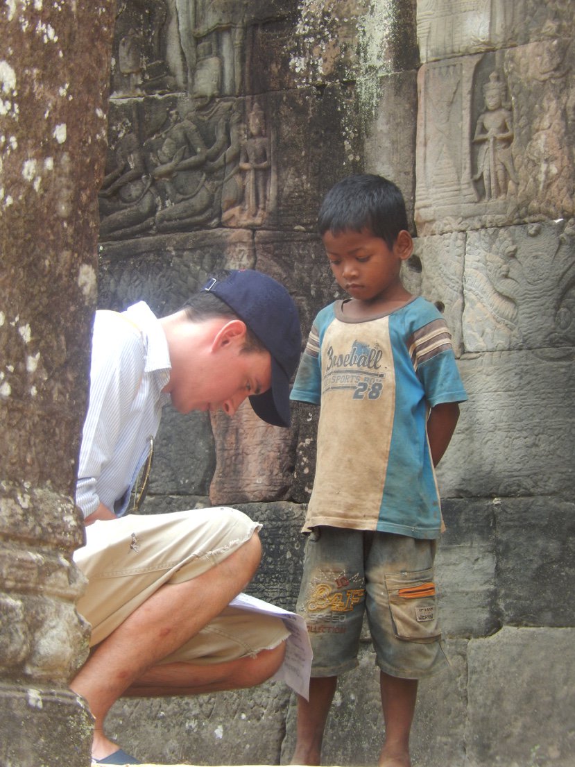 MyFaveBench's tweet photo. My Son Tom helping a local school child at #AnkgorWat in #Cambodia please remember today is  #NationalKindnessDay https://t.co/pEifGQzmVX
