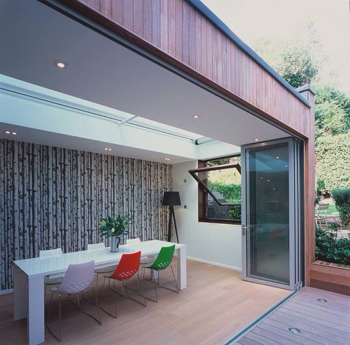A timber-clad extension. The bi-folding doors completely open up the extension to the patio area by Seary Architects. #design #architecture