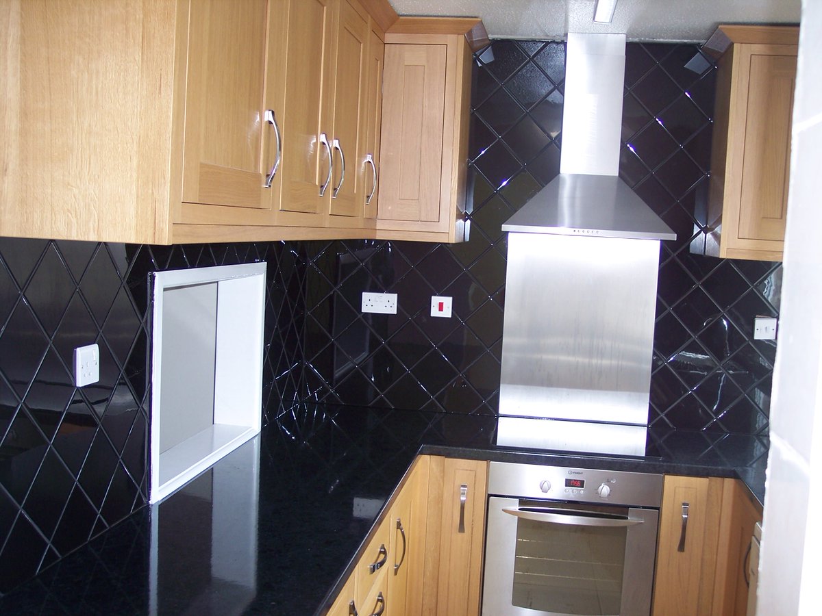These black gloss wall #tiles were fitted on the diagonal to add interest to a compact #kitchen.