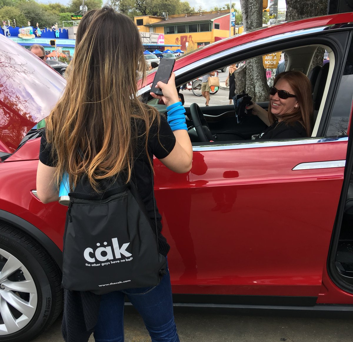 the_cak's tweet photo. Hanging hard in this red Tesla. #tesla #TheOtherGuysHaveNoBalls https://t.co/uJPXDC4snp