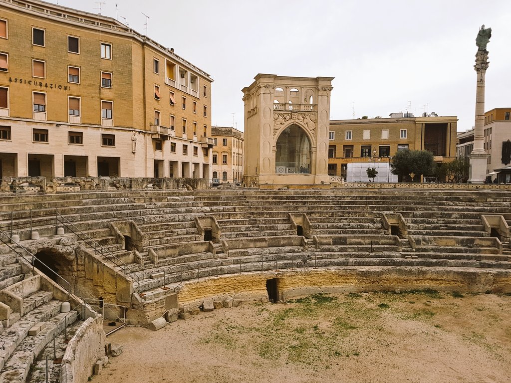 ArchTrav's tweet image. Roman amphitheatre in #Lecce, #Pulia - with the Oronzo column in background