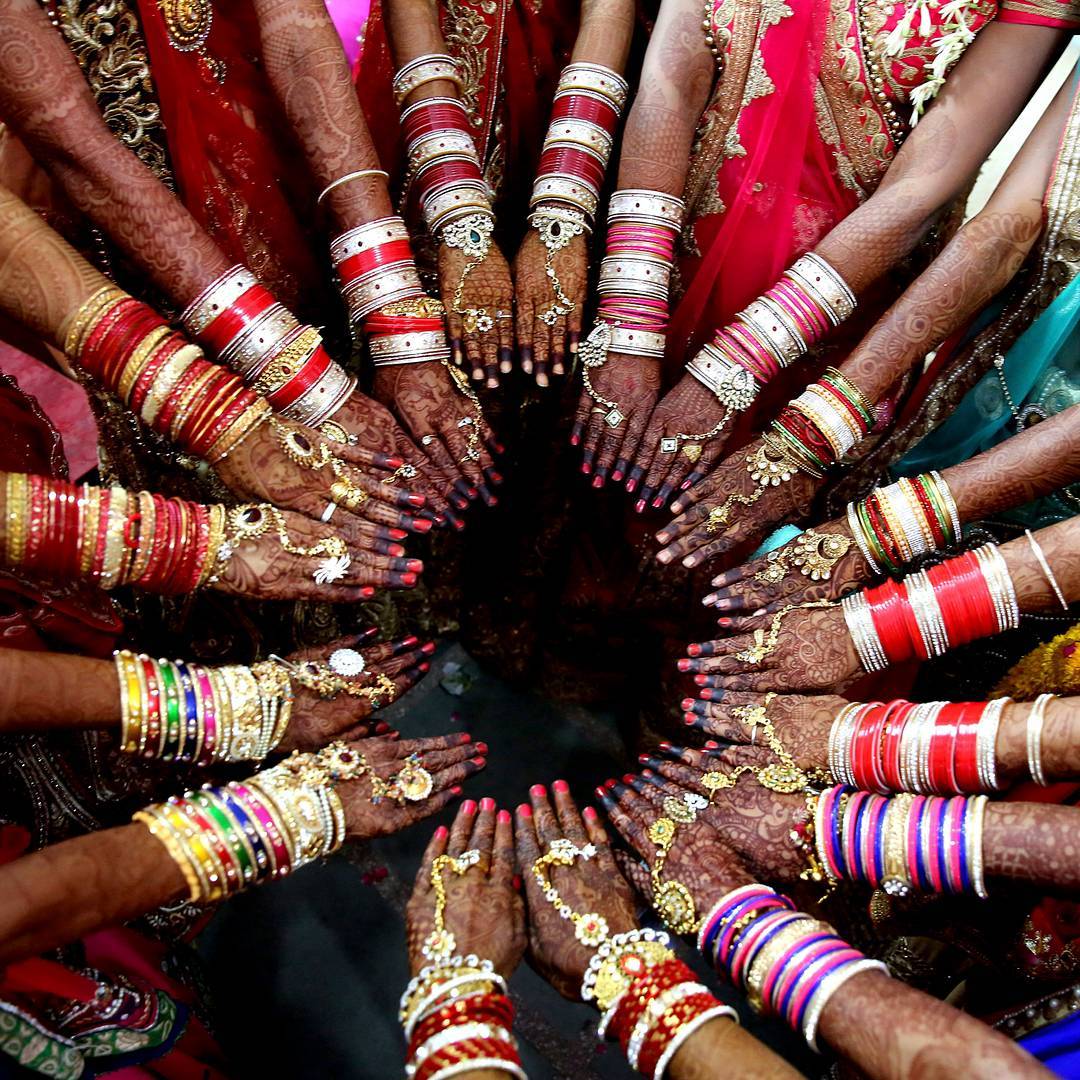 TheEconomist's tweet image. Brides of the Jain community take part in a mass marriage ceremony in Bhopal, India on April 2nd (EPA/Sanjeev Gupta)