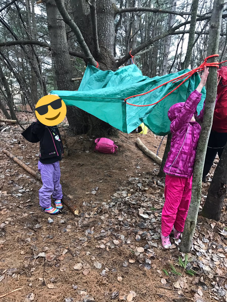 Roasting hot dogs &amp; marshmallows! We had to build our own shelters to stay dry from the pouring rain-although staying dry didn't last long..