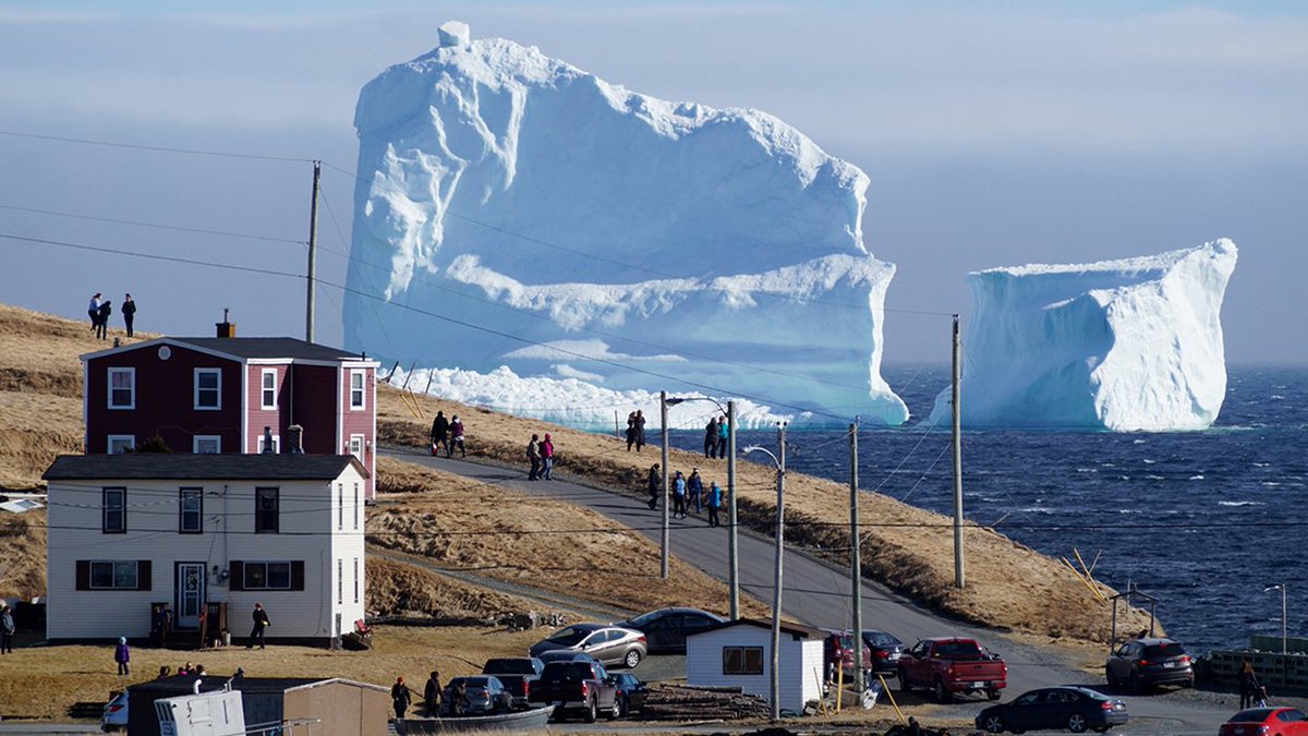 TheEconomist's tweet image. Residents view the first iceberg of the season as it passes the South Shore in Newfoundland, Canada on April 16th 2017 (Reuters)