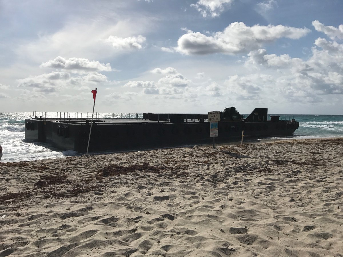 CBS12's tweet photo. Coast Guard says barge broke free from a tug boat early this morning, ran aground on Singer Island. https://t.co/zJcihqKdQL https://t.co/Iu2UnyWA4b