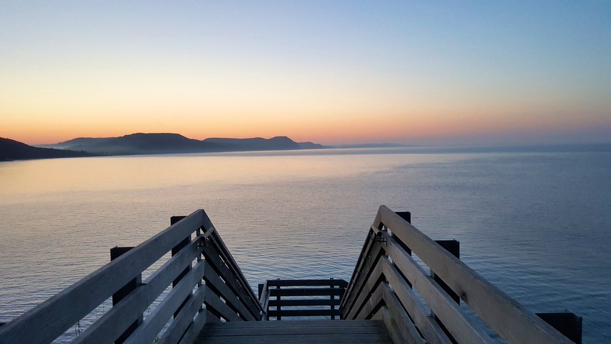 Love_Lyme_Regis's tweet photo. A beautiful orange glow in the sky across the Jurassic coast just before sunrise a few days ago viewed from Lyme Regis #dorset #dorsethour https://t.co/Z3QFSPTUTe