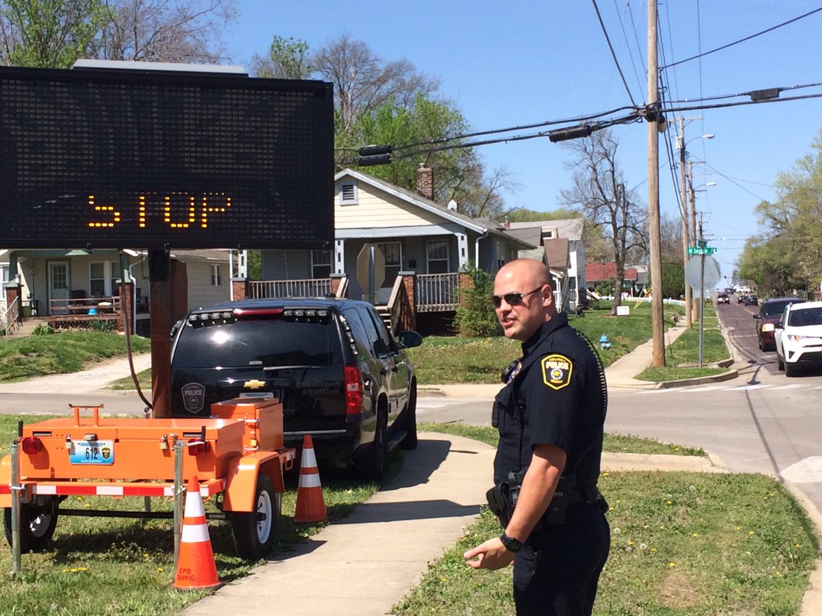 <a href="/CPDAndriaCoMo/">Ofc Andria Heese</a> and Officer Wilson from the traffic unit helping with a sign to remind people to come to a full stop at Sexton/Garth #safety