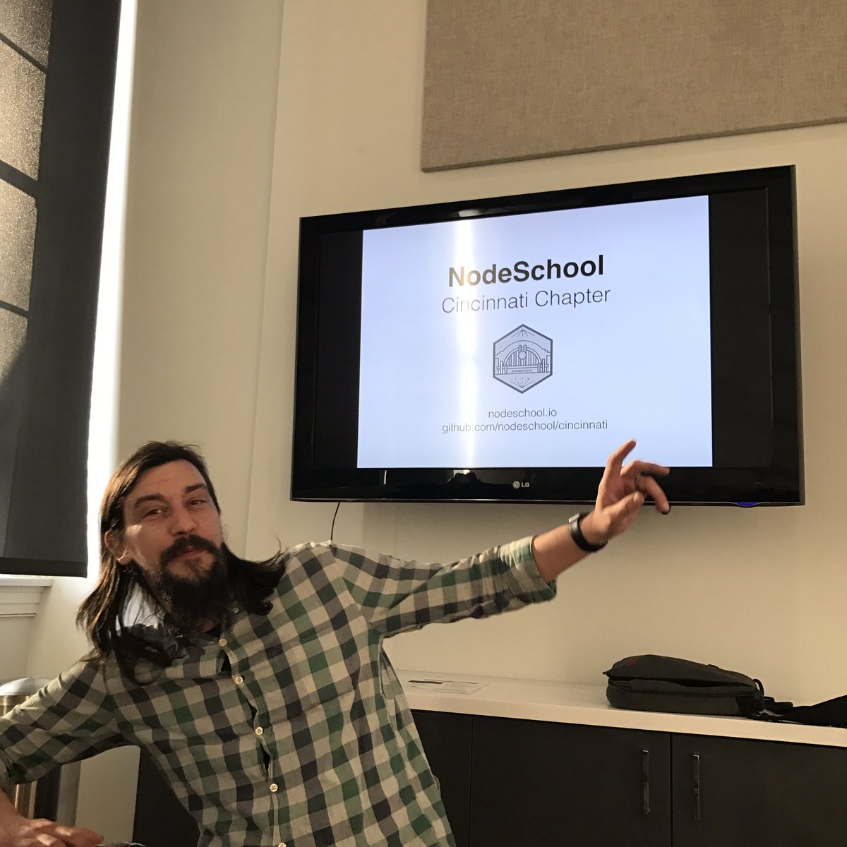 NodeSchoolCincy's tweet photo. Obligatory @jackboberg pointing-at-his-presentation-screen picture. Time for #npm ‼️fun fun fun #nodeschool night 🍻 https://t.co/lXb5n6WcCH