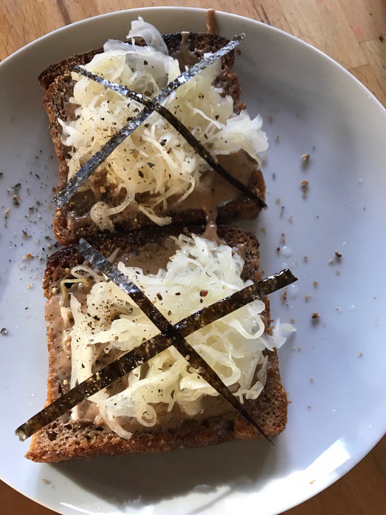 Two toasted slices of wheat free rye toast, slathered with activated almond butter, sauerkraut, nori #Vegan https://t.co/nt0IPmpo61