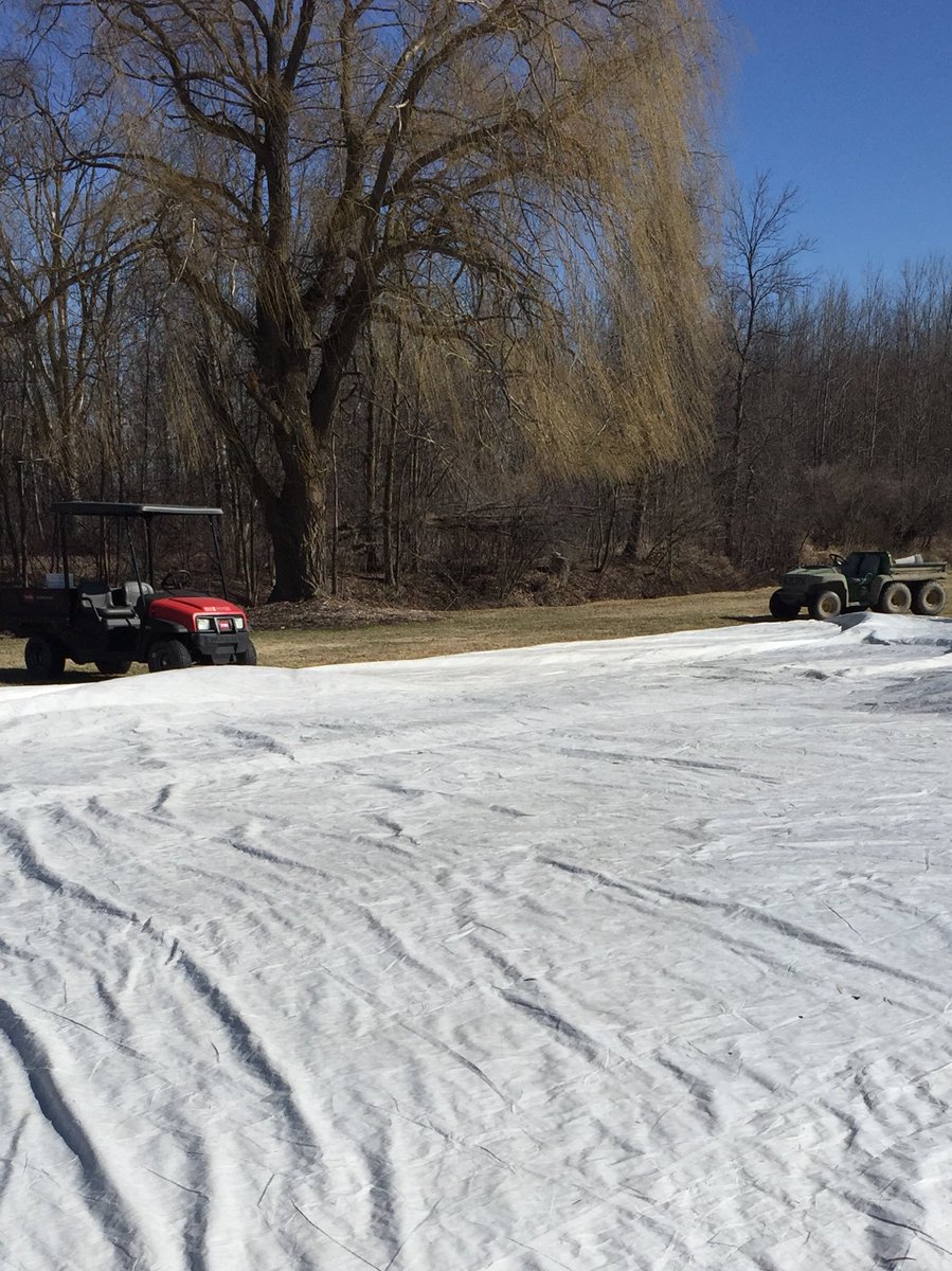 Trying to fold solid tarps today with a little bit of help from our utility vehicles.
