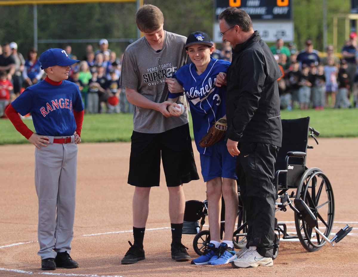 Tristan Ballinger throws out the first pitch of Opening Day at North Oldham Little League.