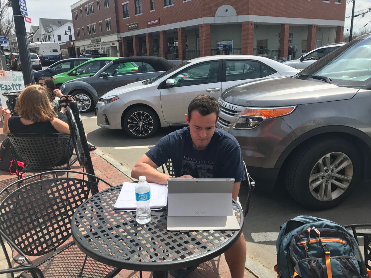LilyWFord's tweet photo. Senior, Will Szostkiewicz sits on Main St. focusing on homework before he heads to class #UNHspring https://t.co/uAJNA0q5O6