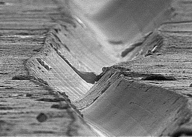 Microscopic image of the surface groove of a #vinyl record. Sublime moonscape meets moonage daydream. #music #microscope #art #sound #design