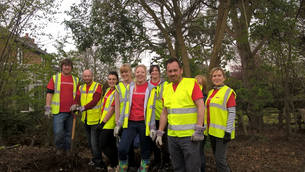 Smartipeople's tweet image. Santander volunteers clearing the muck heap @saintcathsuk for hedgehog homes. Thanks people @santander