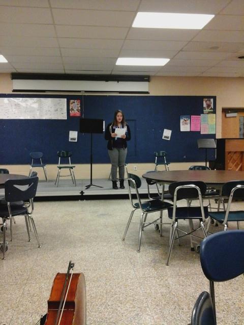 Emily Hess from Creative Writing Club performing her own poem 'How To Not Exist'!