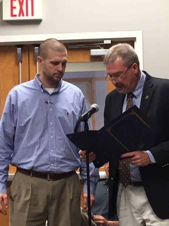 SuptTomSisk's tweet image. Commission chair reads and presents proclamation to West Limestone Coach Taylor in front of team and cheer squad