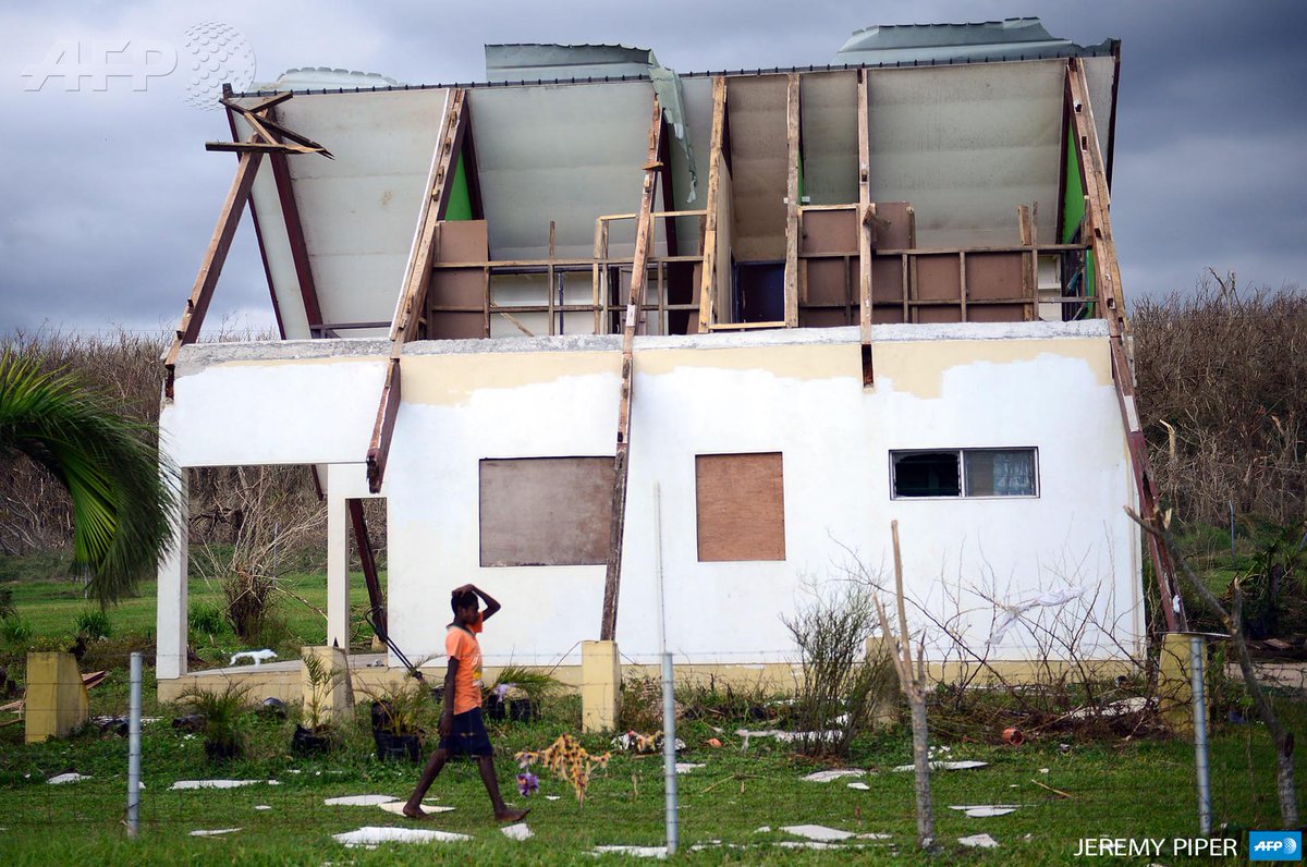 afpfr's tweet photo. #Vanuatu Un garçon passe devant une maison endommagée par le #CyclonePam à Tanna. Photo via @s_chauveauAFP #AFP http://t.co/rYvDEjuCDU