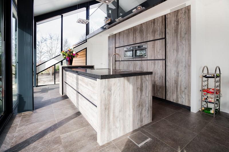 Door veel lichtinval komt deze keuken nog mooier uit en is v.v. van Miele 'downdraft', geïntegreerd afzuigsysteem.