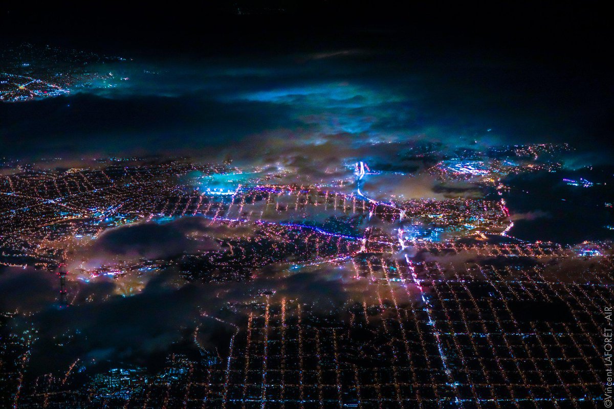 SFMOMA's tweet photo. How stunning is this city w/ that phosphorescent glow? Pics of SF nightlife from 7,200 ft → http://t.co/YW22Ar1KKT http://t.co/JfpSLWuNqp