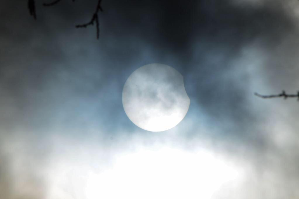 barrabest's tweet image. The beginning of the #Eclipse as seen through the cloud over Lough Neagh this morning. Photo by @AntrimLens: