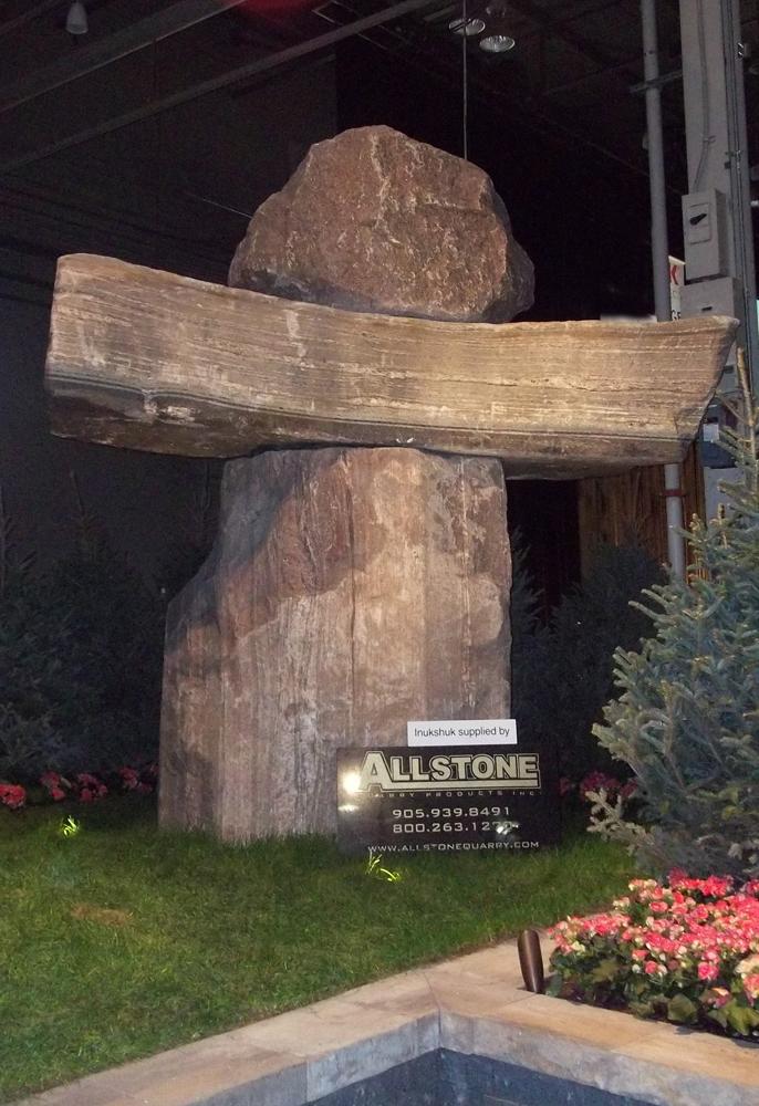 Joe Melo of Allstone Quarry &amp; his massive 10 tonnes Inukshuk on display at the Canada Blooms garden show.
