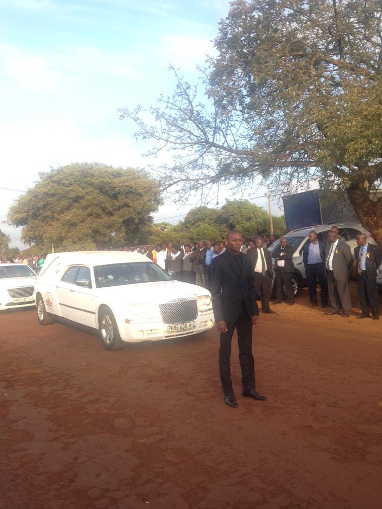 POWER987News's tweet photo. #RIPChabane Son Matimba stands in front of the hearse leading his father to the church service http://t.co/YSp0Q5pdSz