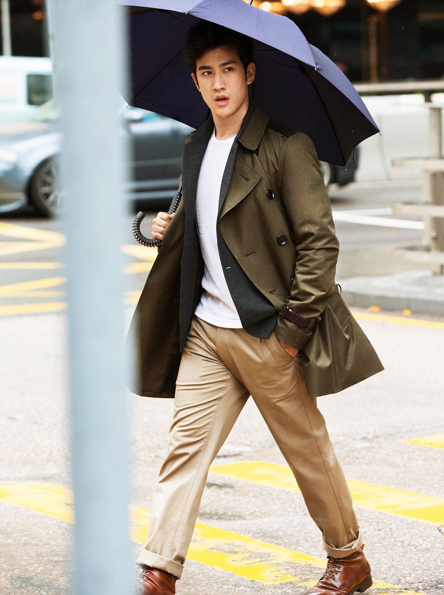 Aarif Rahman wearing a Burberry trench coat on a rainy day in Central ...