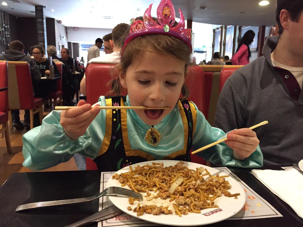 Nikkidee2's tweet photo. Princess Anna, dressed up for her visit to Jimmys, trying to work out to use those darned chopsticks! #LoveJimmys http://t.co/f82CSRSQBm