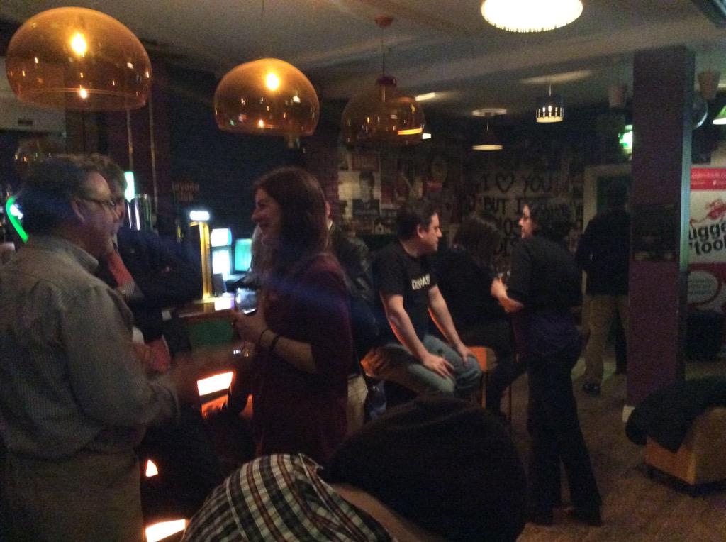 SluggerOToole's tweet photo. Lots of people ignoring Cameron & Miliband on @HudsonBar big screen & settling for old-fashioned chat #tweetupni http://t.co/drRM8ilIBi