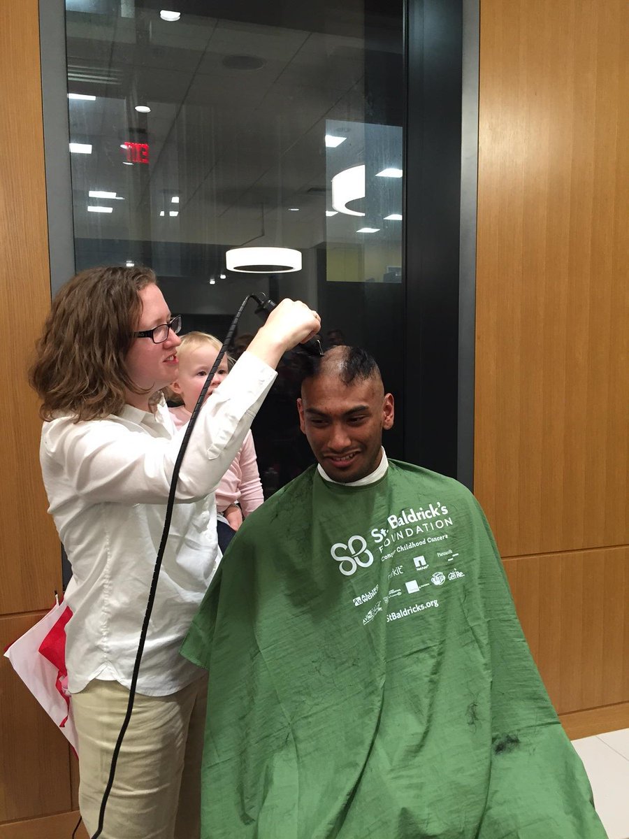 Prof. <a href="/armoncrieff/">Dr. Abigail R. Moncrieff</a> shaves the head of student Omar Aniff during an event to support one of our own battling cancer.