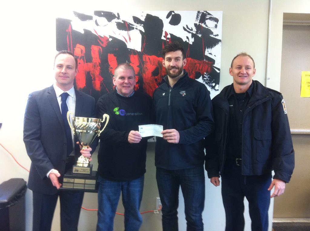 BramptonBeast's tweet photo. .@calwild32 presenting the funds raised from our Guns and Hoses game to Ted Brown of Regen Brampton. #BeastHockey http://t.co/mpLVJ70bLE