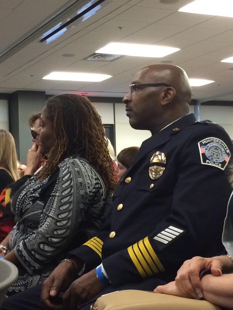 AlexandriaVAPD's tweet photo. .@HPDNC Chief Cleveland Spruill (former APD Deputy Chief) watches on as speeches continue. #APMemorial http://t.co/fIWgnz2G0a