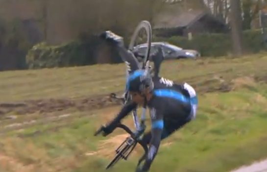 Geraint Thomas crashes, caught out by the wind but he gets up