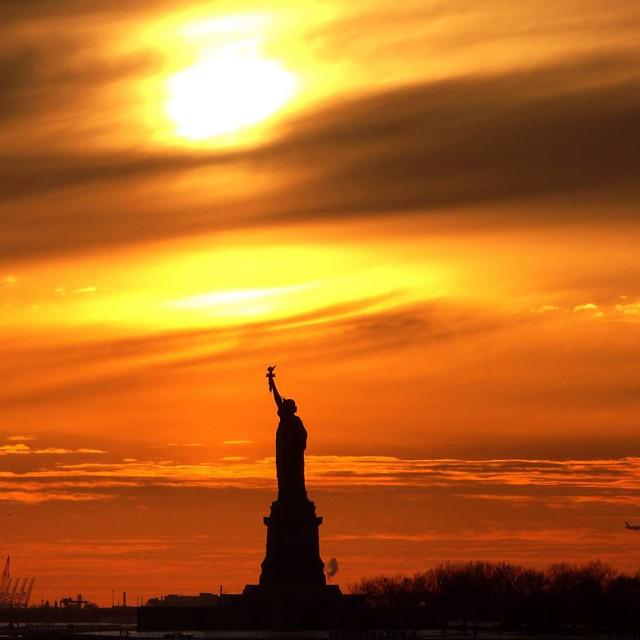 I_LOVE_NY's tweet photo. A beautiful sunset at the Statue of Liberty. Thanks @dawnrussell10 for sharing this photo. #iLoveNYSunsets http://t.co/tEzgO8FBU0