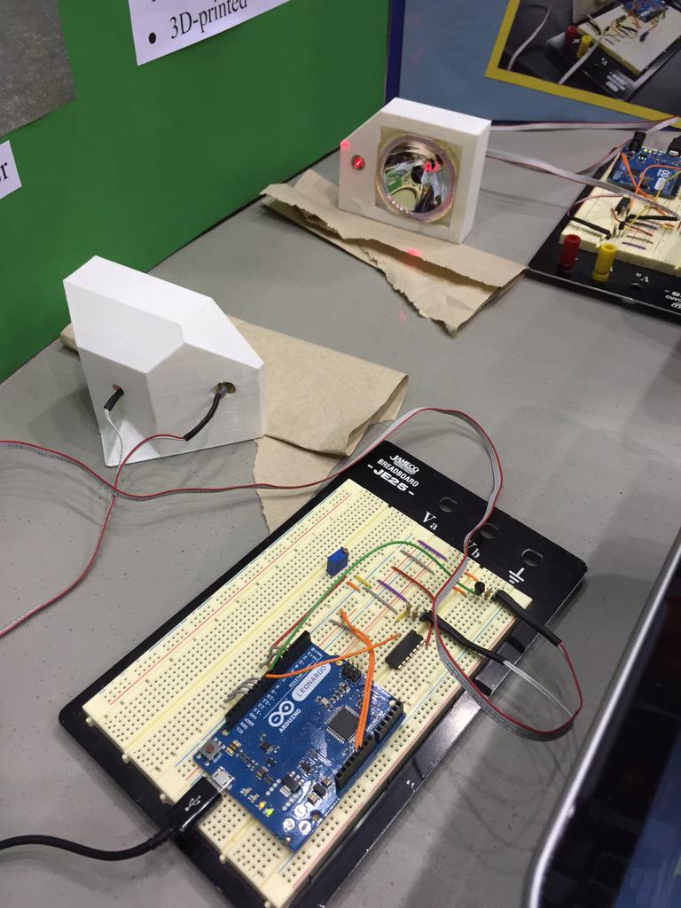 At science fair with student. This STEM project uses a laser transmitter/PIN diode receiver for digital communication