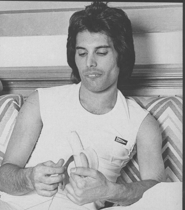 ppleating's tweet image. Freddy Mercury eating a banana.