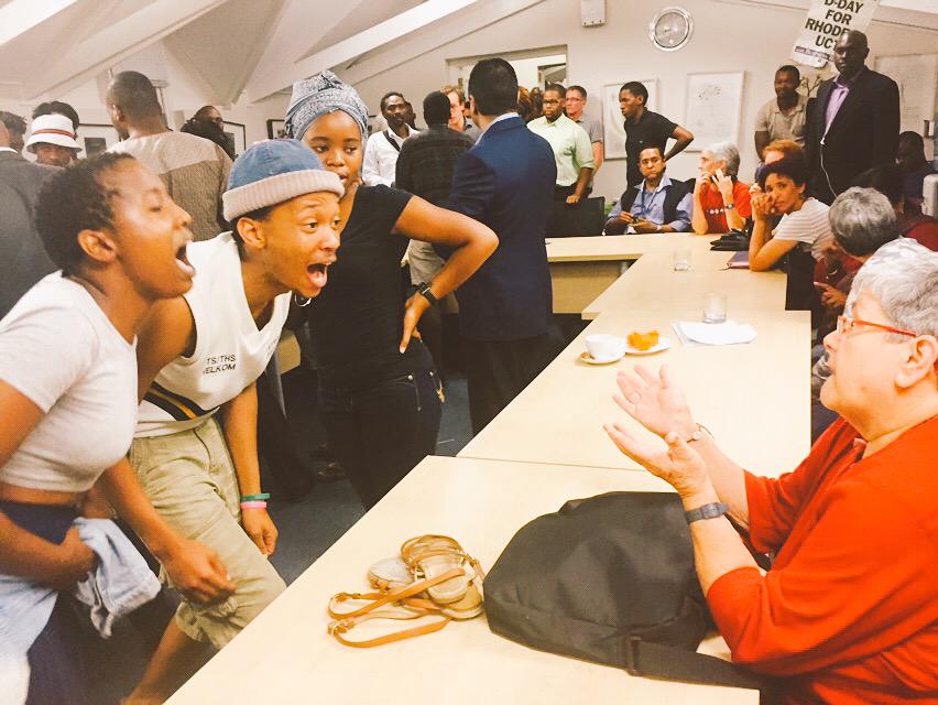 ewnreporter's tweet photo. #RhodesStatue Council member slaps a student on her arm and tensions flare. MK http://t.co/G5NVbt49Ar
