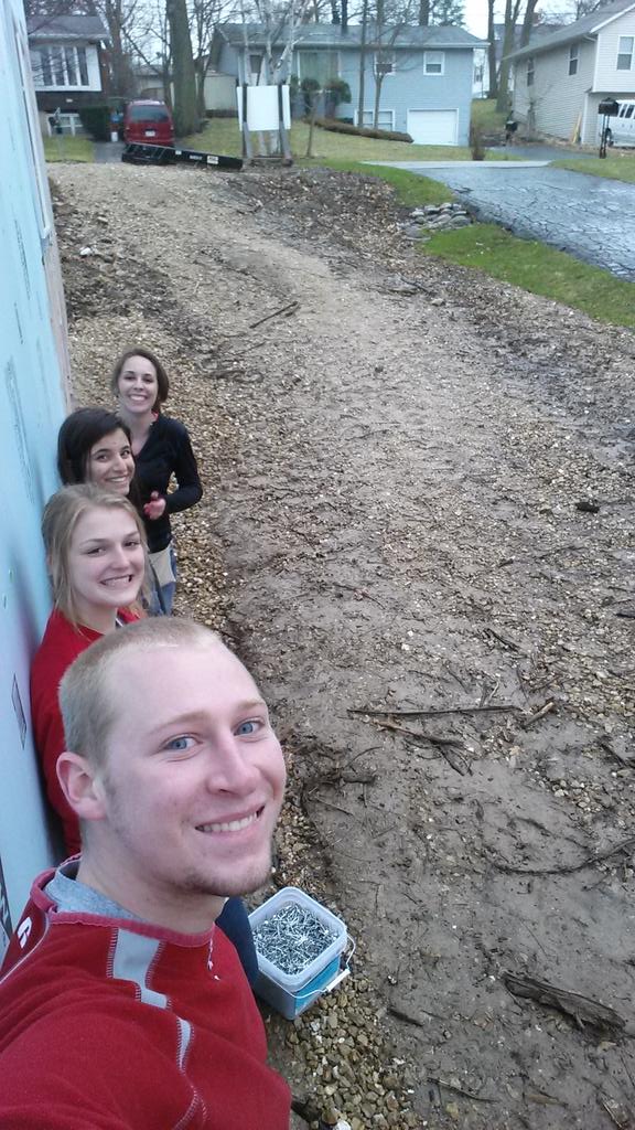 Here are some PLS members hiding from the rain during our build with <a href="/Habitat_org/">Habitat for Humanity</a> here in Madison!