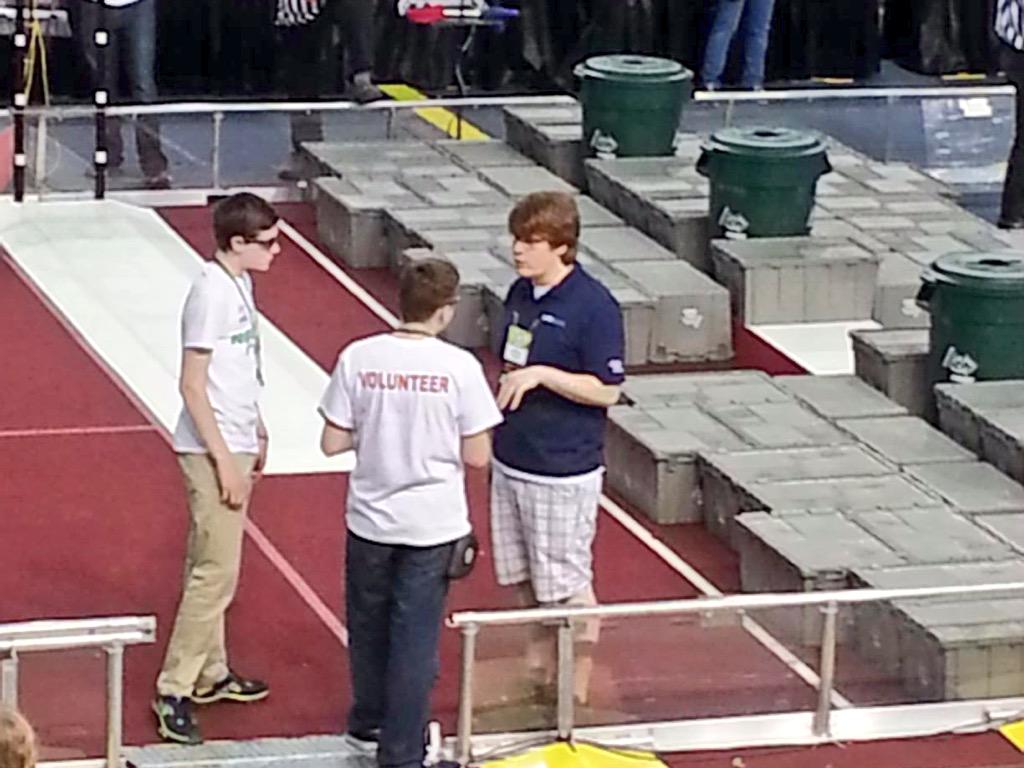 FRC708's tweet photo. Our #dearFieldSupervisor valiantly tells some volunteers what to do. #MARChamps #BrianForTheWin #omgrobots http://t.co/APY0H39QEg