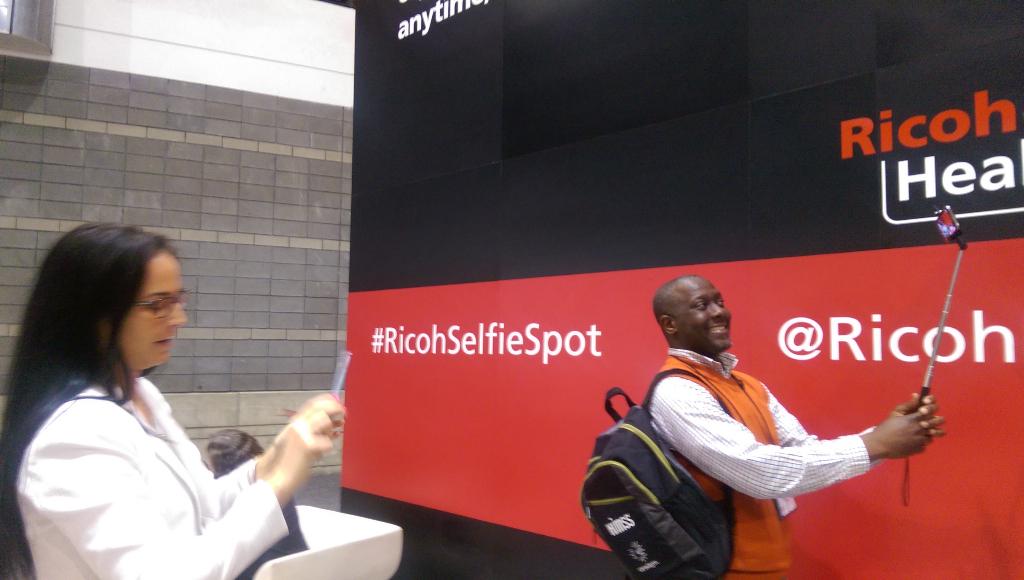 RICOHHealth's tweet photo. Thanks Carl of @PerfectOutput for stopping by the #RicohSelfieSpot @ our booth! Enjoy your #RicohSelfieStick #HIMSS15 http://t.co/p98j90zxxq