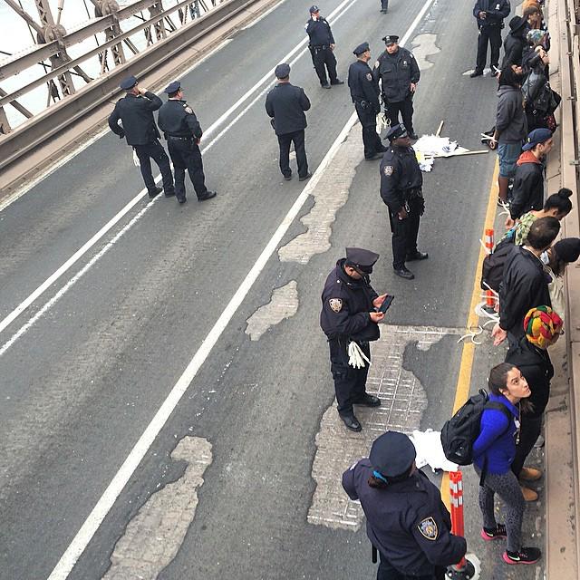 fractenberg's tweet photo. Group of protestors getting arrested after blocking traffic on the Brooklyn Bridge. #shutd… http://t.co/LZKKnVhsmT http://t.co/moAiEMNfyw