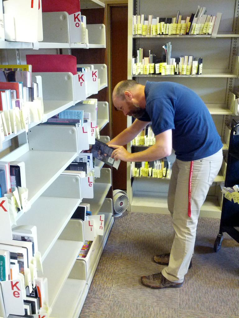 midlibraryorg's tweet image. Brendan shelving some of the hundreds of patron holds that come in everyday. #librariesworkbecausewedo #nlwd15