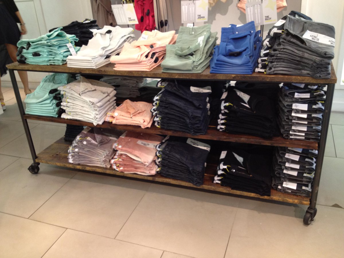 ViraInsight's tweet image. A rustic rolling shelf clothing display combining wood and metal #designawesome