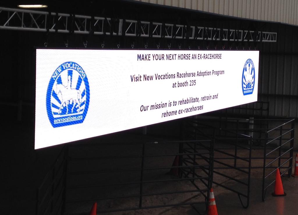 NewVocations's tweet photo. Our sign on the tron @RolexKentucky today! Come see us on this rainy day! #Rolex2015 #OTTB #Lexington #cold http://t.co/9k4IiqYGAC