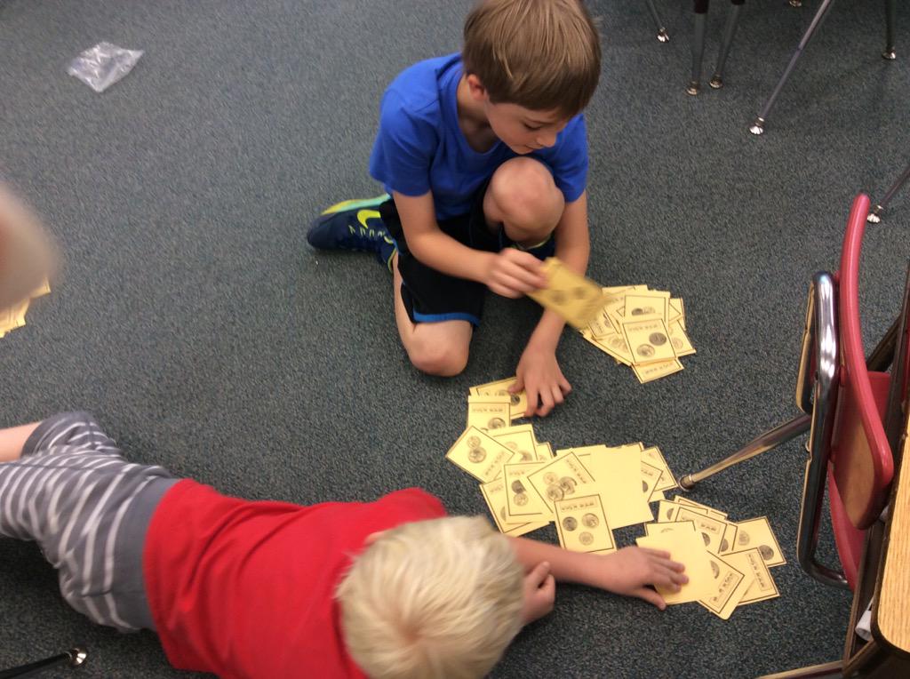 Grade2WolfPack's tweet photo. WolfPack practicing with money. Coin War! @NTMPrincipal http://t.co/EaYV976HGR