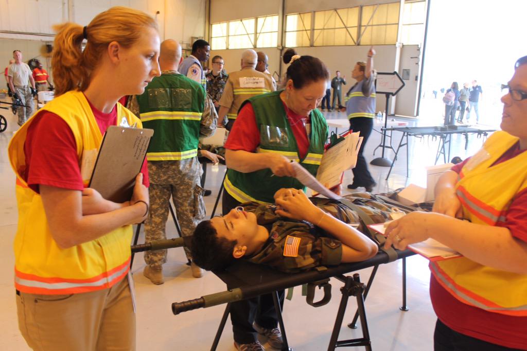 A mock patient is triaged by medical staff after being offloaded from transport plane during #SCNDMS15