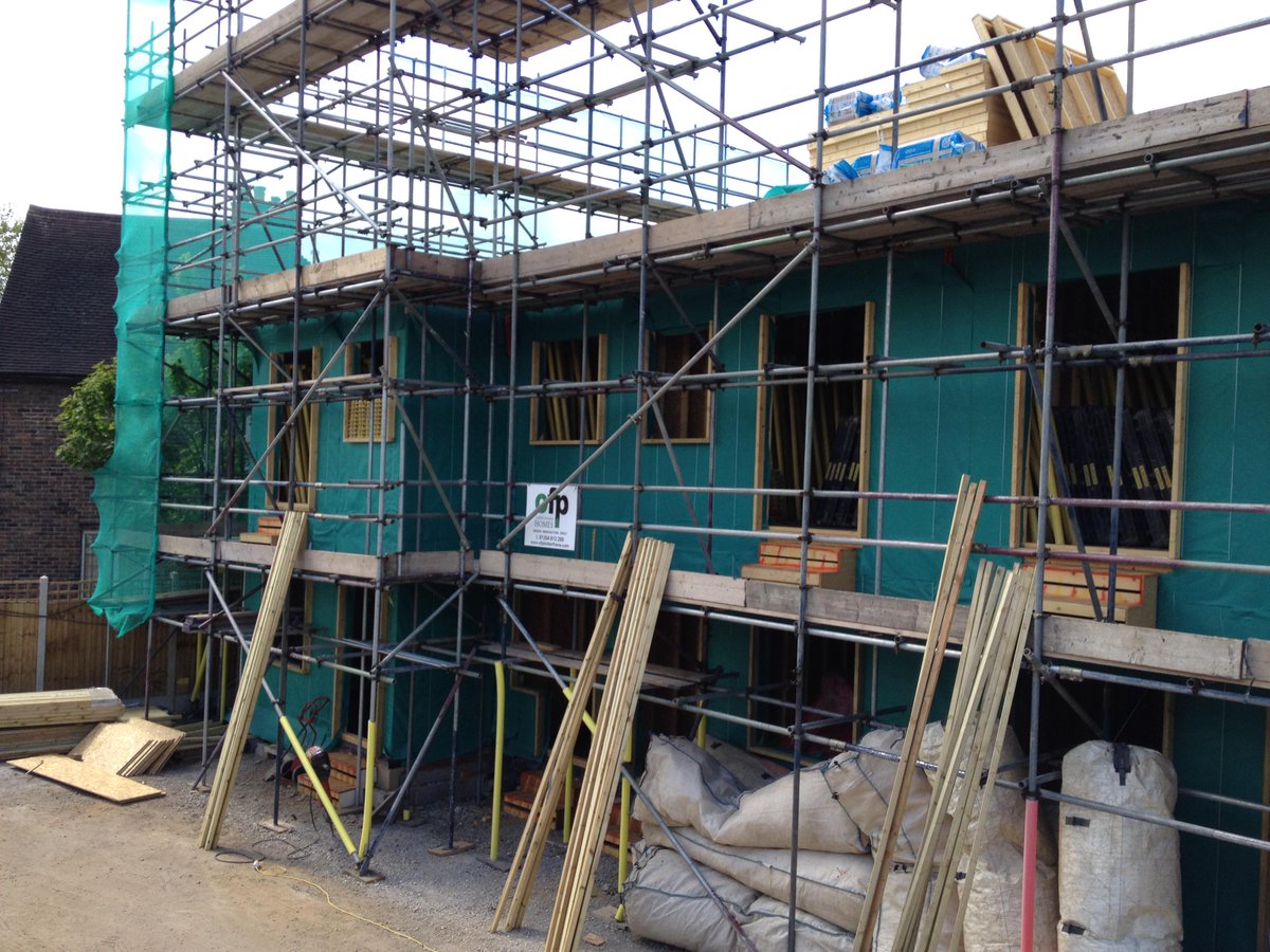 Our frame going up nicely in London. #timberframe #ominousclouds