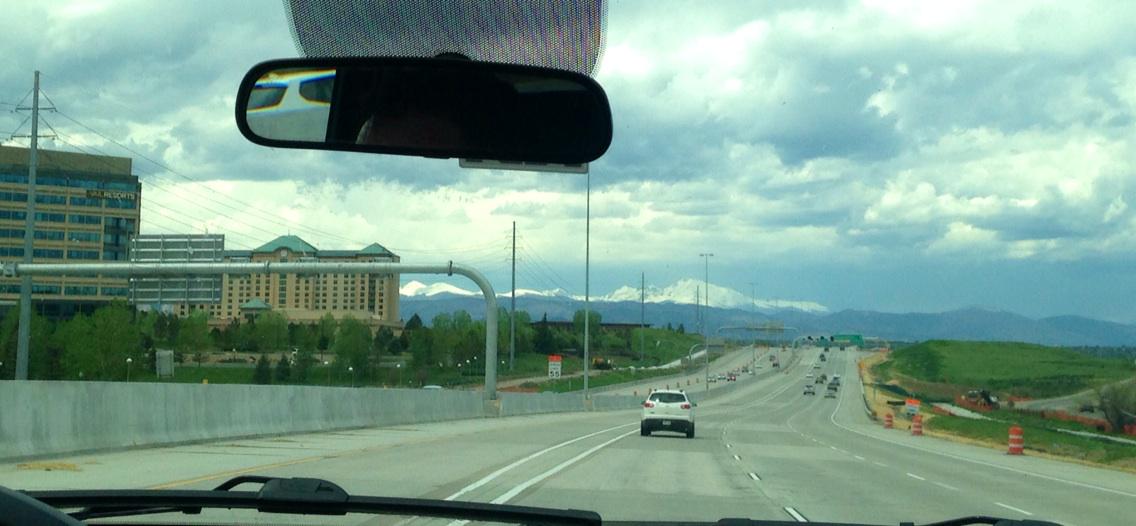 TaMarynWaters's tweet photo. My view via shuttle service from Denver Airport: Snow capped mountains. They look huge from my car  #TalBoulder http://t.co/PQO3hSBo0y