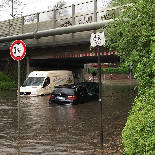banjo's tweet photo. People running to escape the heavy rain pounding #Hamburg right now http://t.co/VQGIXZNf82 #flood #germanyweather http://t.co/3zXJFVCEnn