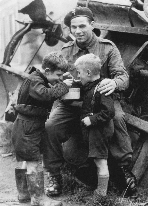 Two Dutch kids get some much needed food from an allied soldier tinyurl.com/o46ub29